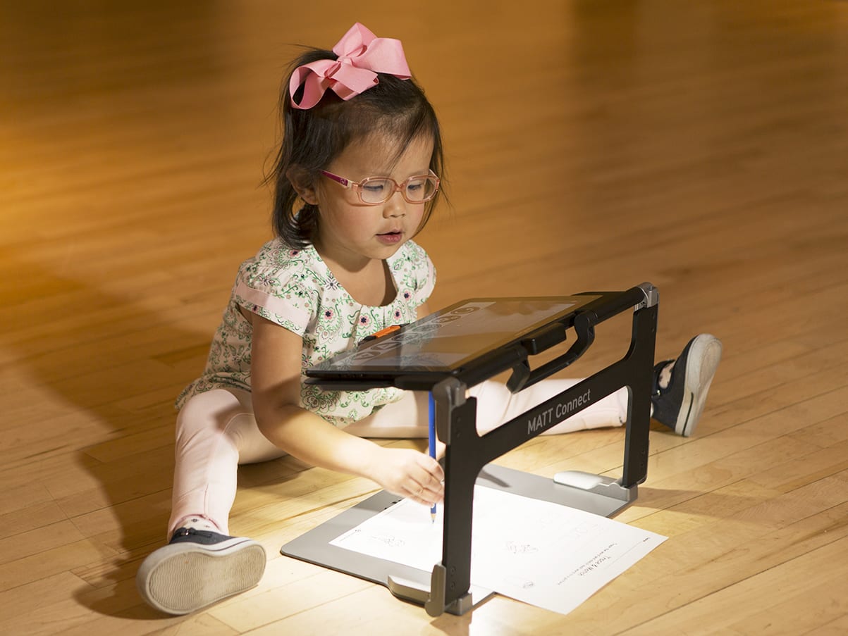 Young girl uses Matt Connect to draw while looking at the magnification on the tablet