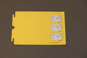 Digital-Recording-Devices-in-OTWL-Sound-Page - An overhead view of a OTWL yellow sound page with three white digital recording devices inserted.