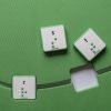 Overhead view of the green mat with square cut-outs and a few green square alphabet tiles.