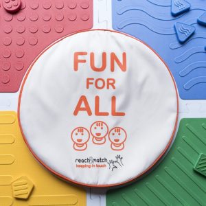 An assembled Reach and Match kit with the "FUN FOR ALL" tile carrying case placed in the center.