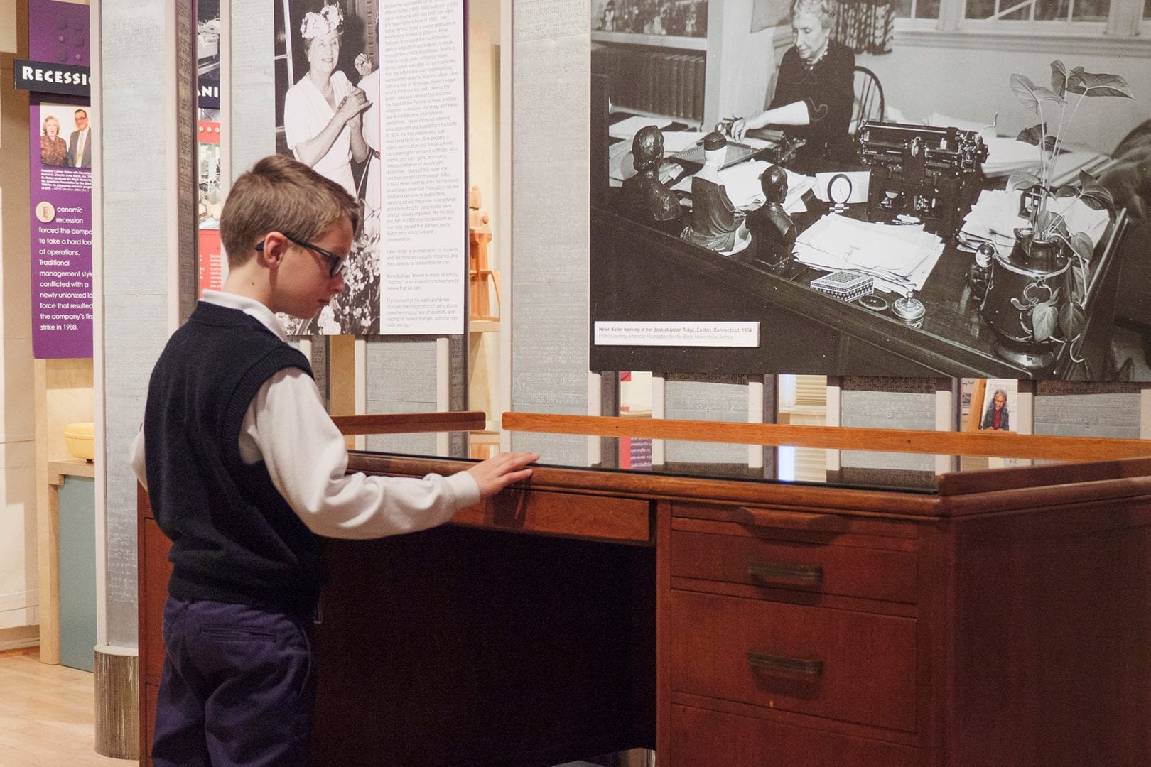 A school boy admiring Helen Keller's Desk