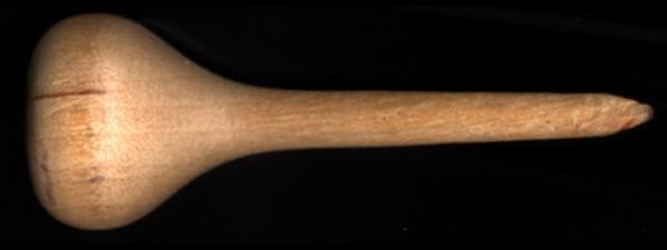 Wooden eraser with one flat side on handle and narrow wooden tip on a black background.