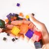 LED mini light box cube set. A pile of several translucent, colorful cubes.