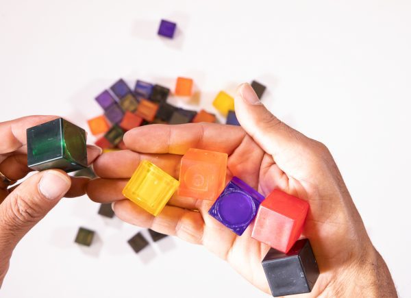 LED mini light box cube set. A pile of several translucent, colorful cubes.