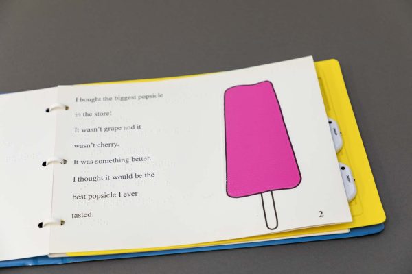 Terrible awful day - A story clipped into the yellow OTWL sound page with two digital device recorders inserted. On the page is an illustration of a pink popsicle next to the large print and braille text.
