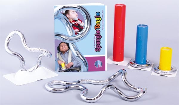 the spangle tangle kit laid out on a table including primary colored standing tubes, user guide, and silver manipulatives in swirly shapes