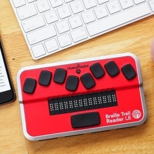 Braille Trail Reader with keyboard and coffee and smartphone