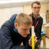 Student measuring the volume of liquid in a graduated cylinder.