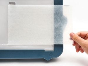 Hand placing Dycem on Mini Light Box