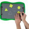 Two hands are tracing a star-shaped yellow stencil with the black stylus on tactile drawing film attached to the green TactileDoodle frame. Above the star is a circle-shaped stencil that has already been traced. To the left are two white tactile outlines of a triangle and a square next to the yellow stencils of the same shapes