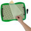 A hand is peeling back a piece of tactile drawing film from a textured crosshatch white sheet attached to the green TactileDoodle frame. The black stylus sits on the right