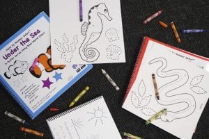a variety of coloring pages and crayons