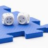 A pair of dice sitting on a blue foam square