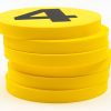 A stack of yellow foam dots. The top dot has a black number 4 printed on top.