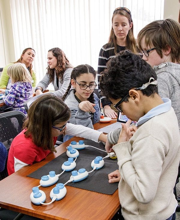 teacher and students assemble a Code Jumper sequence