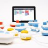 Code Jumper pods on a table in front of a tablet displaying the Code Jumper app