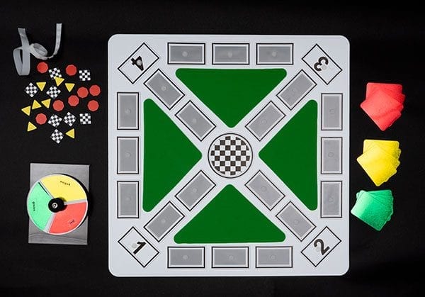 Color Raceway game board, pieces, reflective color cards and spinner on black background