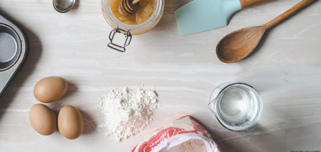 An assortment of ingredients and kitchen tools commonly used for baking.