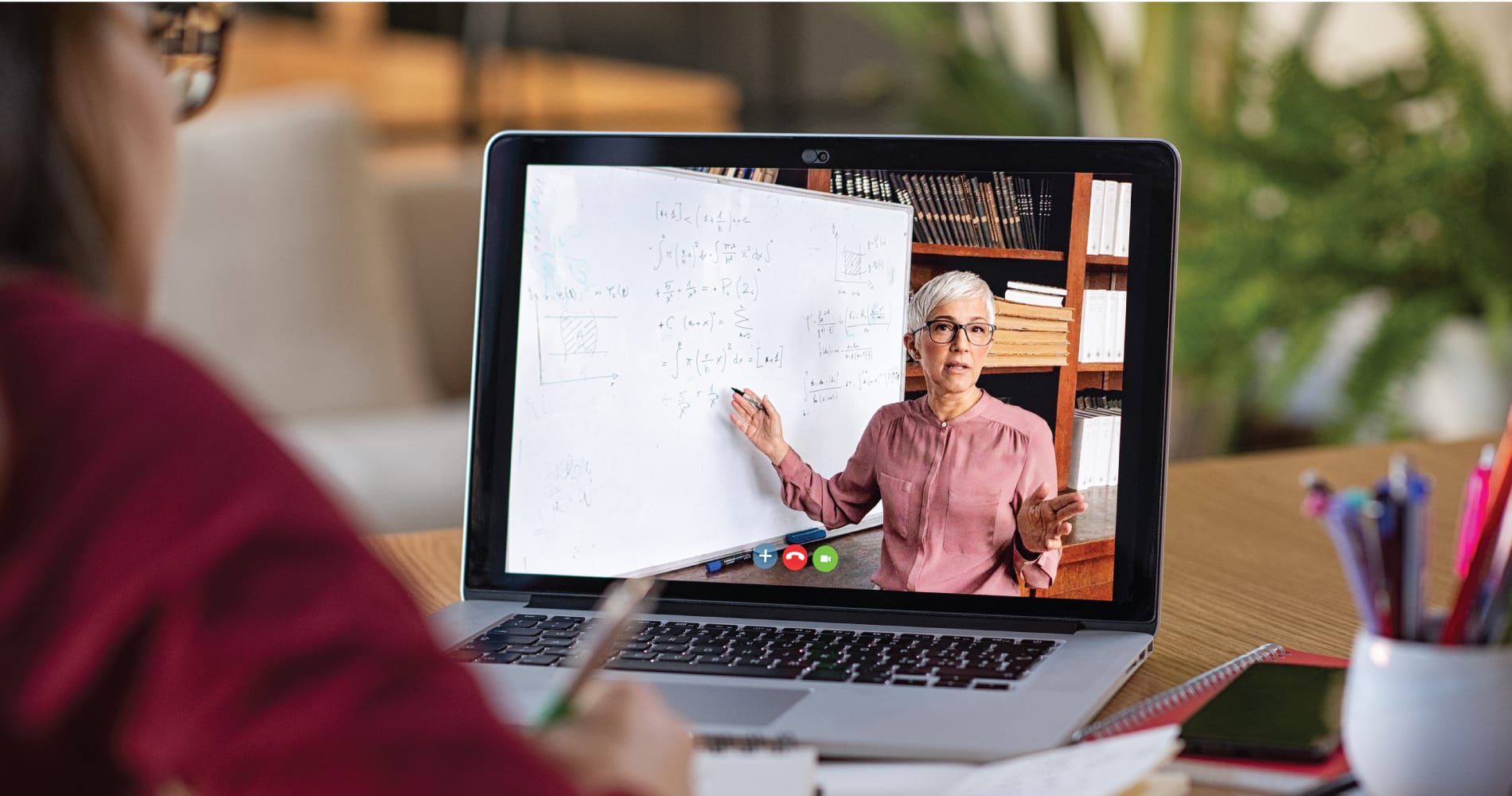 Person watching a webinar on a MacBook