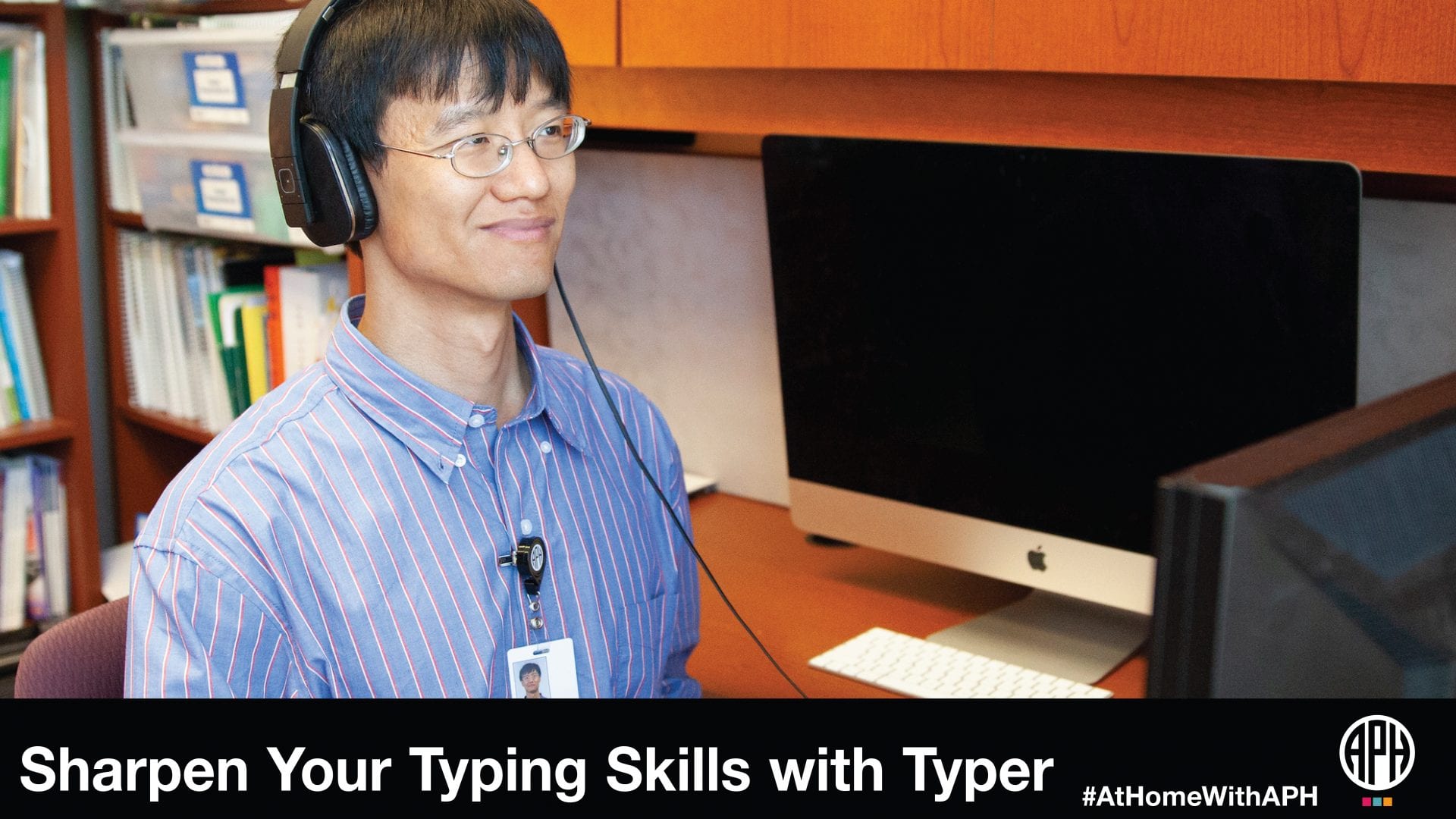 a man with glasses wearing headphones and sitting at a computer. text reads "Sharpen your typing skills with typer. #AtHomeWithAPH" APH logo