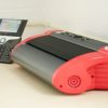 PageBlaster embosser on a desk next to an office phone