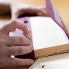 Sideview of two hands using Quick Pick Cards with case and picker