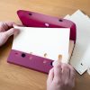 two hands using Quick Pick Cards with case and picker