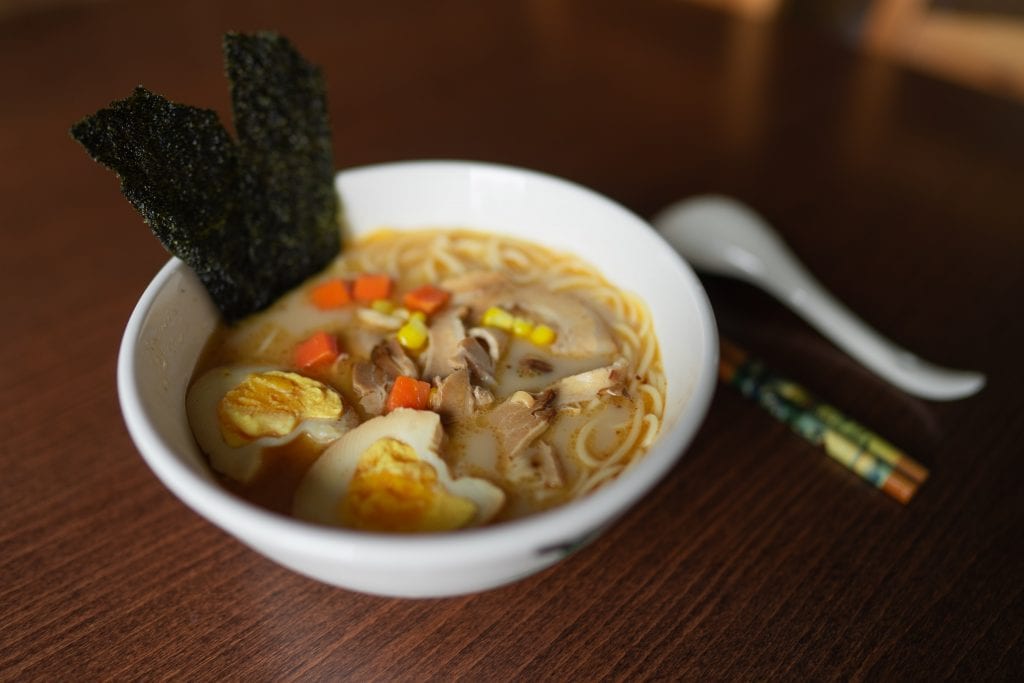 a bowl on ramen noodles on a table