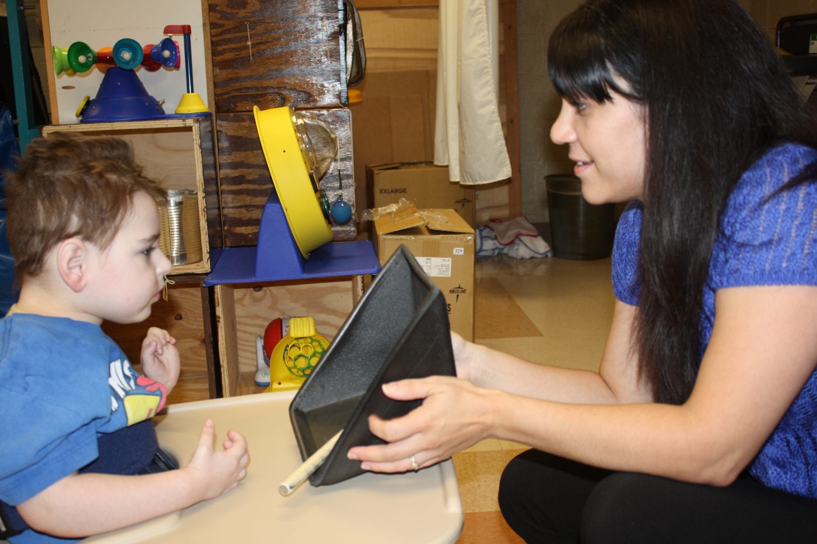 Max’s teacher uses a blue screen accommodation to reduce visual complexity.]