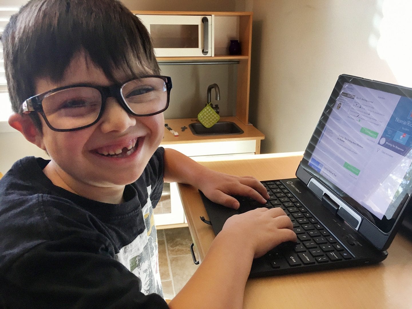 Smiling student at a laptop