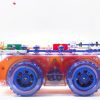 side view of RC Snap rover, a bread board covered in snap circuits pieces sitting on a frame with wheels.