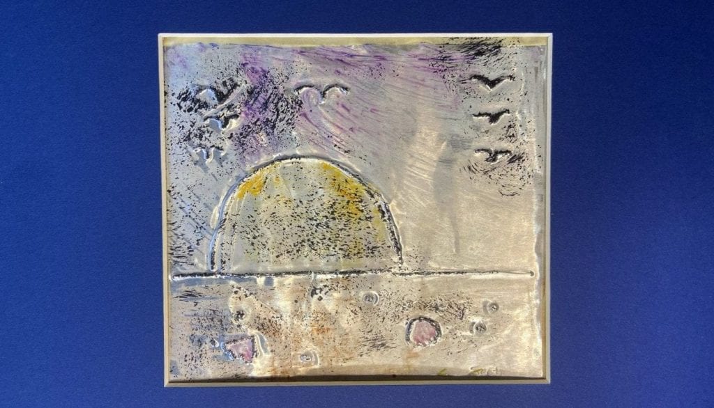A square foil canvas on a blue background. The canvas is decorated with paint and a drawing in relief depicting a sunset on the water as seen from the beach with birds flying overhead.