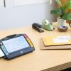 Juno magnifying text on an envelope on a desk
