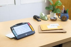 Juno magnifying text on an envelope on a desk