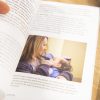 The Babies with CVI book is held open to a page that includes an image of a woman and infant.