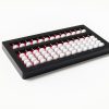 abacus with white beads, a red background, and a black frame