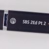 Close-up of the black Step-by-Step Part 2 thumb drive against a white background. In white lettering, it says "SBS 2Ed Pt 2.