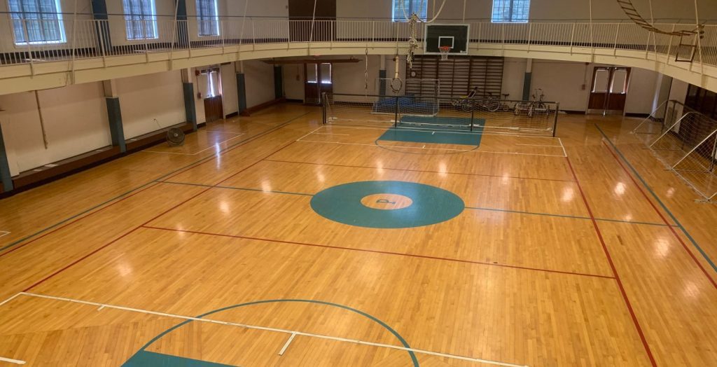 An aerial view of a basketball court with a wooden floor.