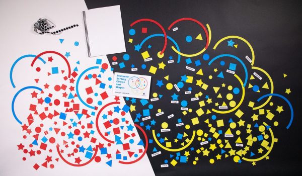 A picture of large textured circles that overlap. Inside are differently textured shapes including stars, circles, triangles, and squares in shades of red, yellow, and blue.