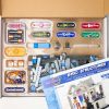 An open kit with the BRIC: Structures components neatly sorted into plastic dividers. The BRIC: Structures instruction manual sits on top.