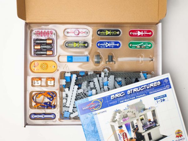 An open kit with the BRIC: Structures components neatly sorted into plastic dividers. The BRIC: Structures instruction manual sits on top.