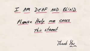 A piece of paper with words in black ink, underlined in red, reading 