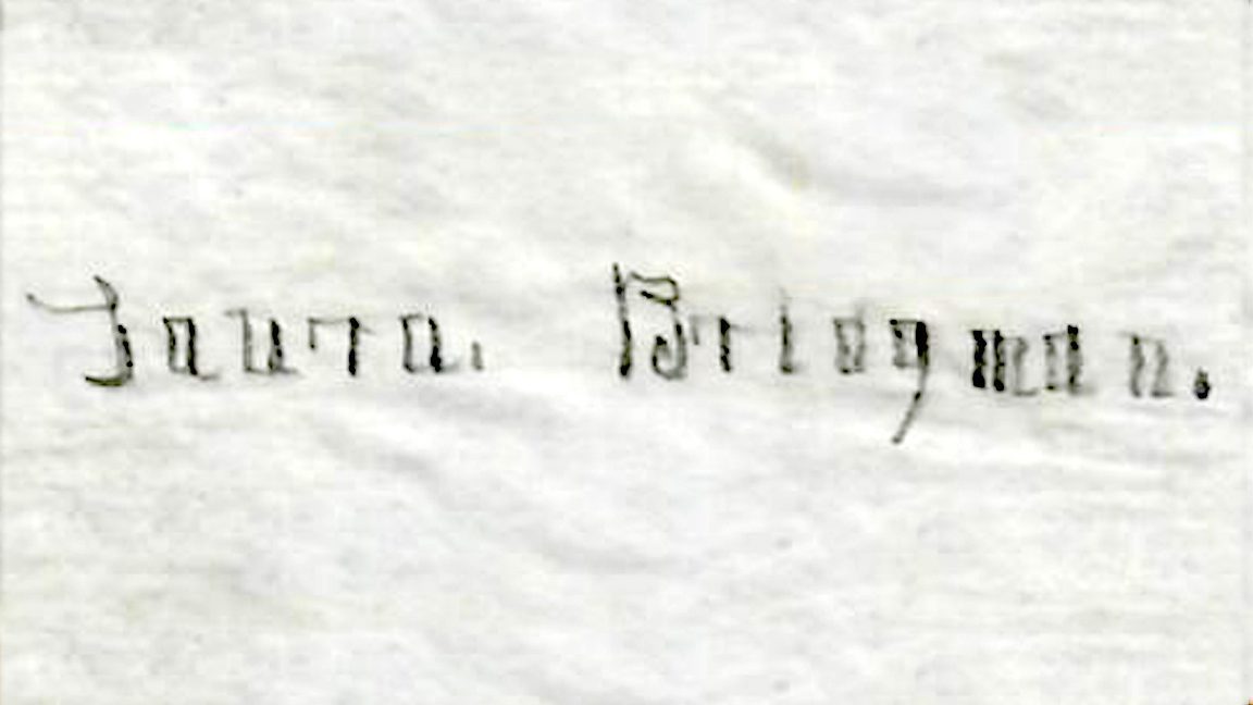 A worn and weathered piece of paper with the signature of the name Laura Bridgman squarely written.