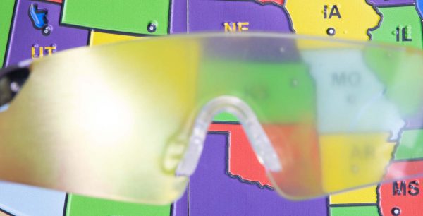 Close up of safety glasses containing the cataracts insert in front of a tactile map of the United States. This image gives an idea of how an individual with cataracts would see the map