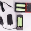 DC Supplement Adapter shown with battery recharger and four batteries.