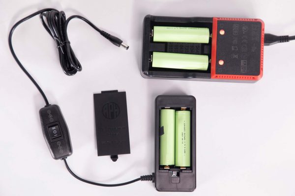 DC Supplement Adapter shown with battery recharger and four batteries.