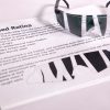 A pair of safety glasses containing the Detached Retina insert sits on top of a printed page with information about the condition and an image of the insert laid flat