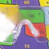 Close up of safety glasses containing the Diabetic Retinopathy insert in front of a tactile map of the United States. This image gives an idea of how an individual with Diabetic Retinopathy would see the map.
