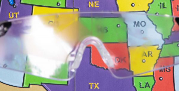 Close up of safety glasses containing the Diabetic Retinopathy insert in front of a tactile map of the United States. This image gives an idea of how an individual with Diabetic Retinopathy would see the map.