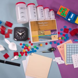 Bird's eye view of MathBuilders Unit 5 Kit: Measurements and Estimation spread out to show the kits’ components including an analog clock, clock face sheets, metric-English measurement ruler, a guidebook, and more.